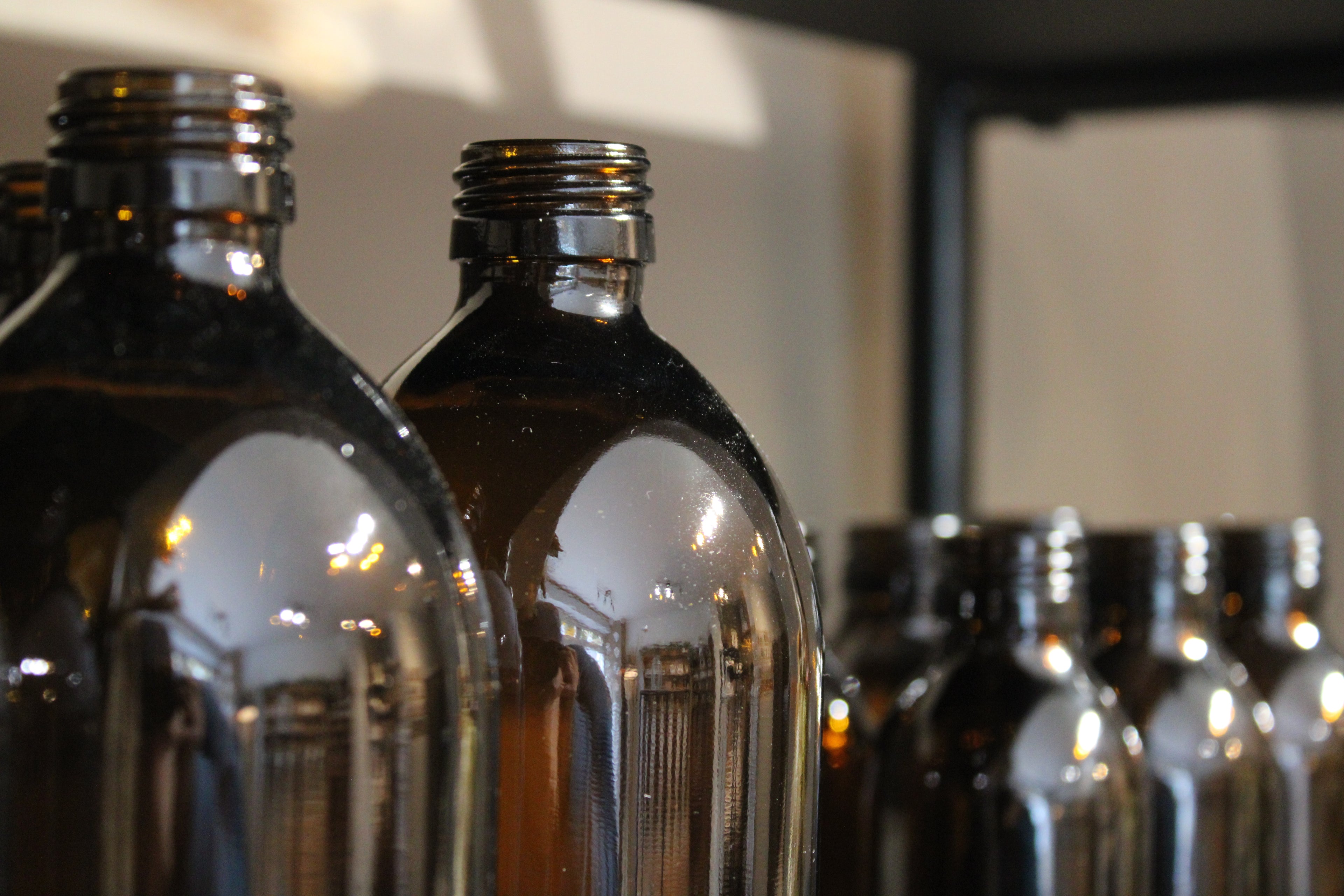 Amber Bottle Vases Display - Leocadia Dartmouth Shop Interior Display