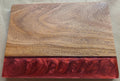 Wooden cutting board with copper/orange resin